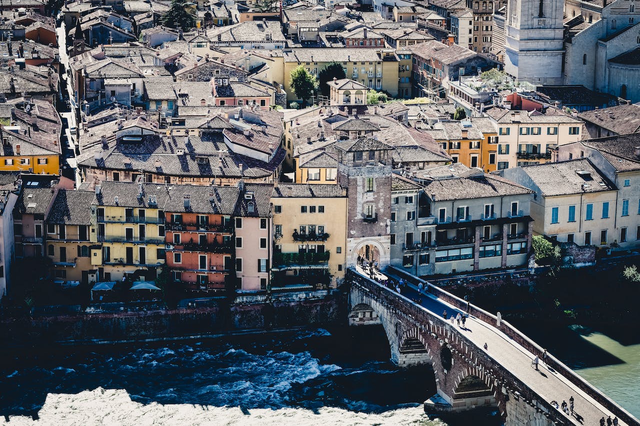 concrete buildings near a bridge and river